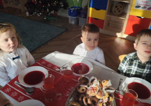 Dzieci spożywają barszcz czerwony.