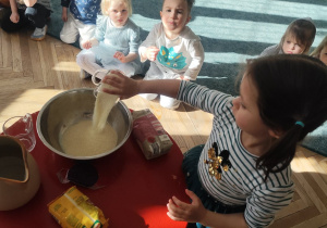 Dziewczynka dodaje składniki do mannoliny.