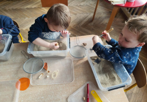 Dzieci pracują z własnym stanowiskiem archeologa.