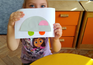 Dziewczynka prezentuje swoją pracę